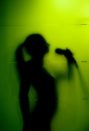 Young woman behind the matte glassの写真素材