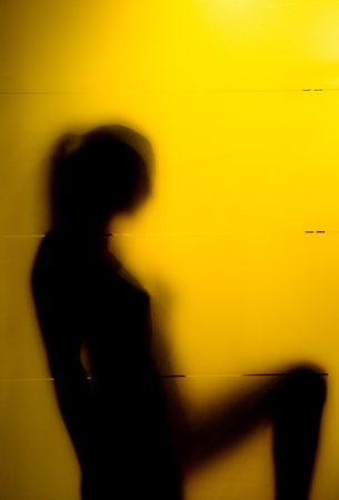 Young woman behind the matte glassの写真素材