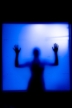 Young woman behind the matte glass