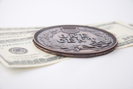 Large Souvenir Cent Coin and dollar banknotes on white background