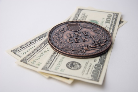 Large Souvenir Cent Coin and dollar banknotes on white background
