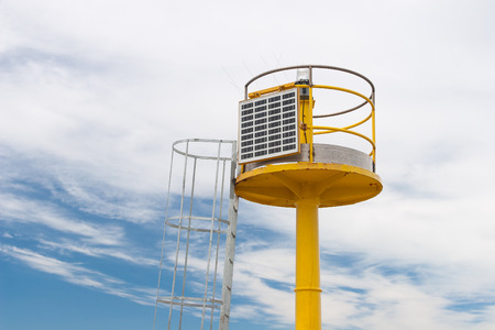 Modern Metal Yellow Lighthouse at sea coast