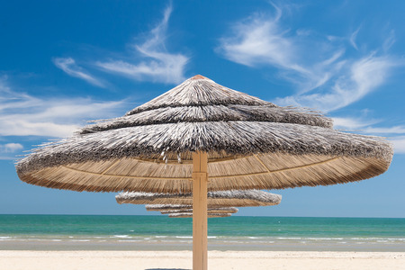 Sunshade Umbrellas on the beach at summer dayの写真素材