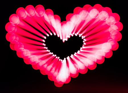 Glowing heart on dark backgroundの写真素材
