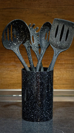 Used black with white dots plastic kitchen utensilsの写真素材