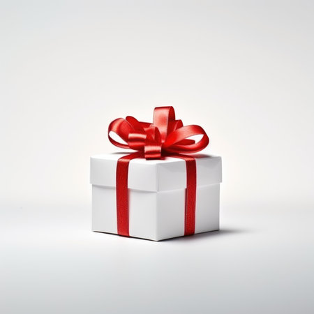 white gift box with red bow isolated on white backgroundの素材