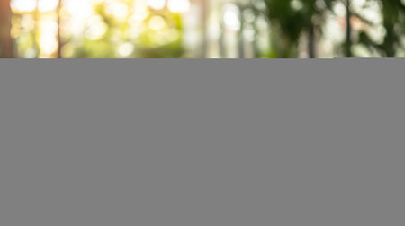 A serene space featuring yoga mats neatly arranged on a wooden floor, complemented by a lush plant in the background, promoting tranquility and wellness.の素材