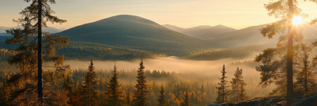 Foggy mountains at sunset with trees in the foreground create a serene landscape scene,.の素材