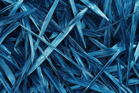 A detailed view of vibrant blue grass against a stark black background,.の素材