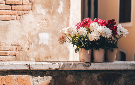 Three colorful flower pots arranged neatly on a ledge create a vibrant display.,の素材