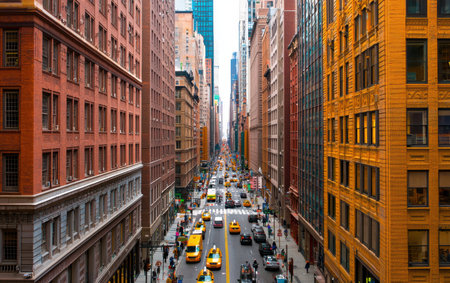 Busy urban street filled with cars and yellow taxis bustling through the city.,の素材