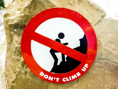 sign red  don't climb up in park  