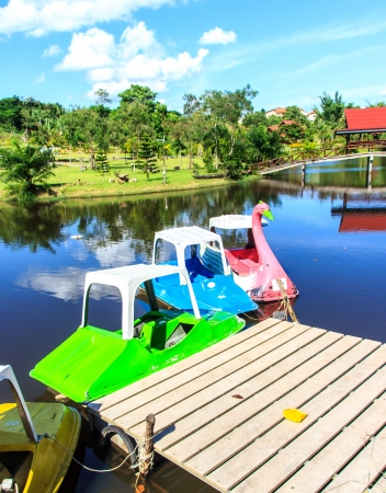 Bridge and pedal boats on garden のeditorial素材