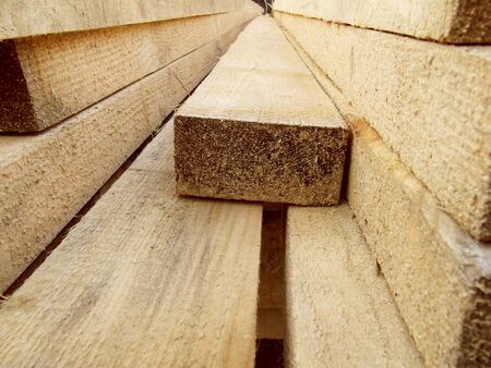 Stack of wooden boards. Building material. Wood storage.