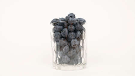 The ripe blueberries in the crystal glass.の写真素材