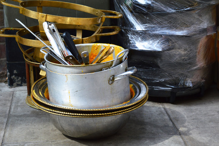 A stack of dirty cooking pots sitting on the streetの写真素材