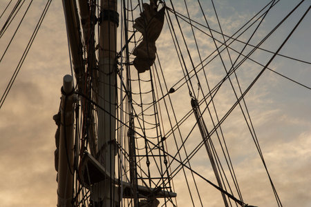 Closeup shot of a sailing ships rigging and mast against a moody skyの写真素材