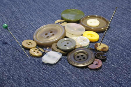 pile of buttons on blue clothの写真素材