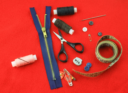 Tailoring accessories on red clothの写真素材