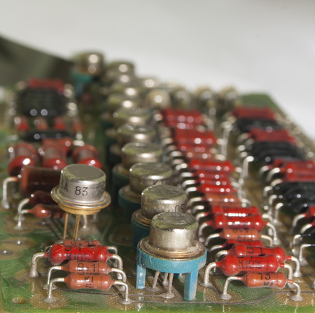 old vintage printed circuit board with electronic components closeup