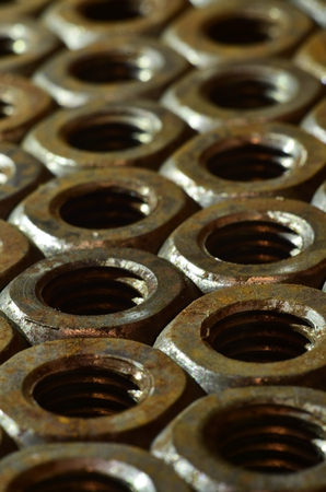 Closeup of a pile of rusty nutsの写真素材