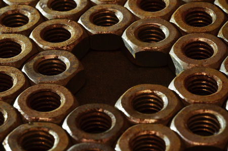 Closeup of a pile of rusty nutsの写真素材