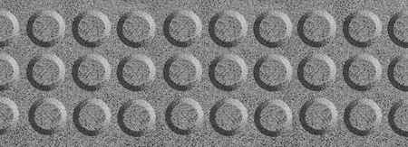 The texture of solid granite tiles. Hard and slippery gray granite surface with a relief discharge...