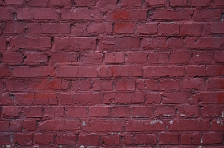 Weathered stained old block wall background. Texture of an old wall of several floors with lots of rows of blocksの写真素材
