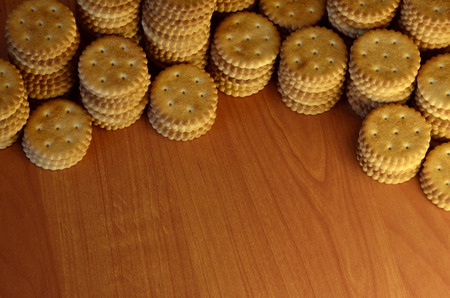 Background image of classic salty cracker on a brown wooden table with copyspaceの写真素材