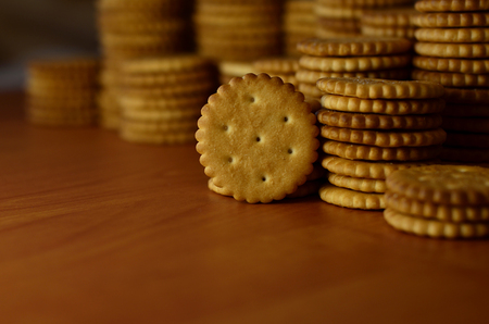 Background image of classic salty cracker on a brown wooden table with copyspaceの写真素材