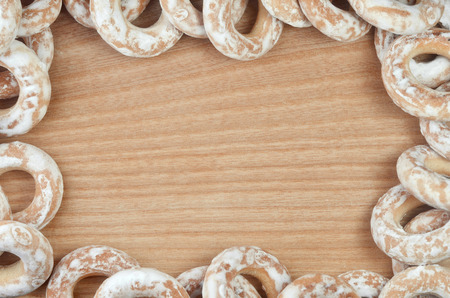 Background image of a variety of glazed donuts, which lie on a wooden table with space for text or any contentの写真素材