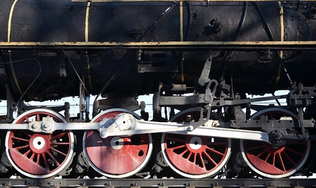 Red wheels of old USSR black steam locomotive. Wheels of an old soviet steam trainの写真素材