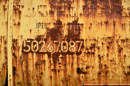 Rusty metal texture with scratched surface. Old painted metal wall with peeling paint. Texture obsolete painting metal fence close-upの写真素材