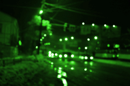 Blurred Defocused Lights of Traffic on a Wet Rainy City Road at Night - Commuting at Rush Hour Conceptの写真素材