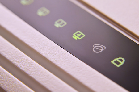 Closeup of internet router LED lights showing connection status. Emitting diode wireless on white plastic internet wi-fi cable modemの写真素材