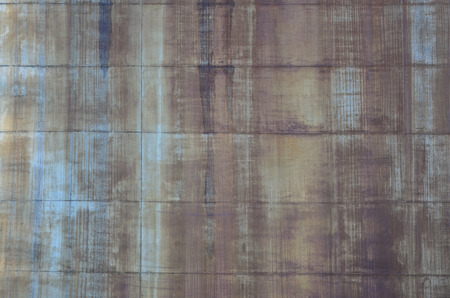 Rusty metal texture with scratched surface. Old painted metal wall with peeling paint. Texture obsolete painting metal fence close-upの写真素材