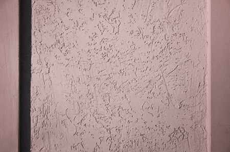 Concrete wall texture with colored plaster. Beautiful design facade painted plaster walls with small pits of various shapes. The texture for the walls in the interior or exteriorの写真素材