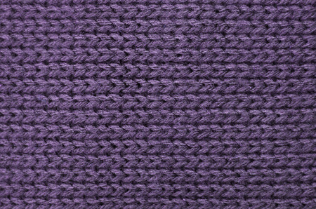 The texture of a knitted sweater wallpaper. Woolen fabric for wallpaper and an abstract background