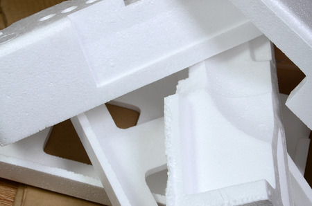 Background image with beige cardboard paper and styrofoam boxes disgarded as rubbish. The concept of unpacking new home appliances out of the carton boxの写真素材