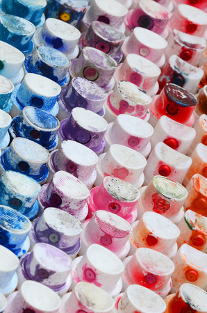 A pattern from a many nozzles from a paint sprayer for drawing graffiti, smeared into different colors. The plastic caps are arranged in many rows forming the color of the rainbowの写真素材