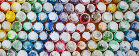 A pattern from a many nozzles from a paint sprayer for drawing graffiti, smeared into different colors. The plastic caps are arranged in many rows forming the color of the rainbowの写真素材