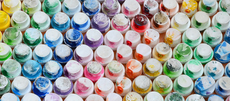 A pattern from a many nozzles from a paint sprayer for drawing graffiti, smeared into different colors. The plastic caps are arranged in many rows forming the color of the rainbowの写真素材