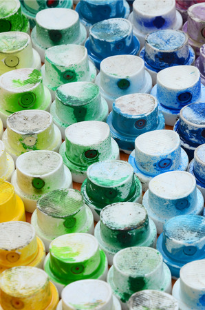 A pattern from a many nozzles from a paint sprayer for drawing graffiti, smeared into different colors. The plastic caps are arranged in many rows forming the color of the rainbowの写真素材