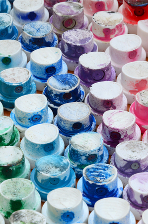 A pattern from a many nozzles from a paint sprayer for drawing graffiti, smeared into different colors. The plastic caps are arranged in many rows forming the color of the rainbowの写真素材