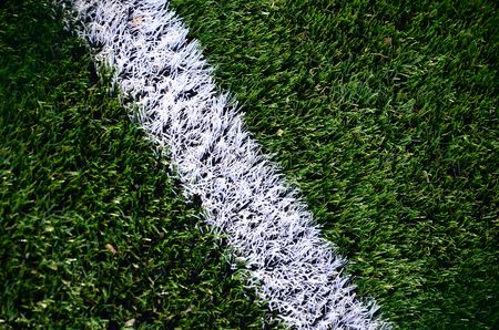 White stripe on a bright green artificial grass soccer fieldの写真素材