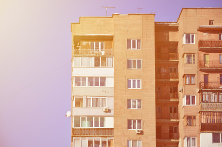 Detailed photo of multi-storey residential building with lots of balconies and windows. Hostels for poor people in Russia and Ukraine in a damaged conditionのeditorial素材