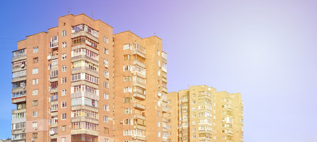 Detailed photo of multi-storey residential building with lots of balconies and windows. Hostels for poor people in Russia and Ukraine in a damaged conditionのeditorial素材