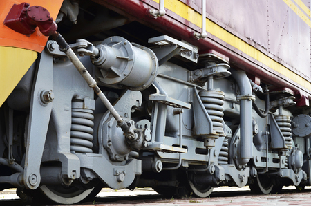 Wheels of a Russian modern locomotive, view from side. Transportation industry concept. Heavy wheels and mechanism under the electro trainのeditorial素材