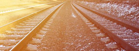 Details snowy Russian winter railway under bright sunlight. The rails and sleepers under the December snow. Russian Railways in detailの写真素材