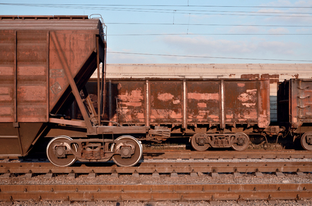 Detailed photo of railway freight car. A fragment of the component parts of the freight car on the railroad in daylightの写真素材